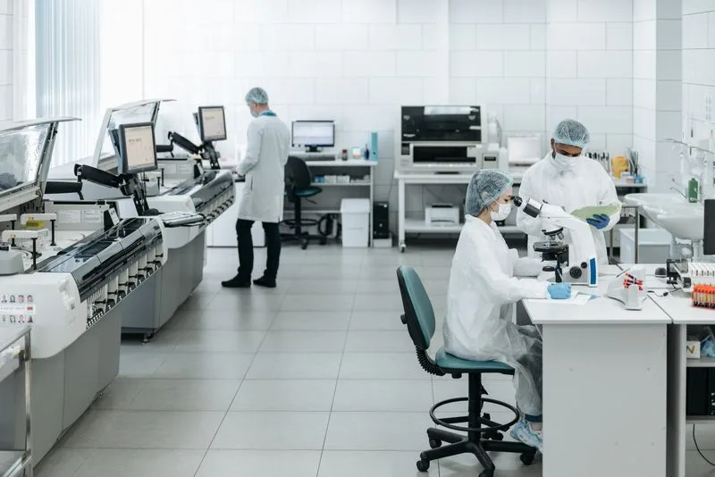 Researchers working with advanced equipment in a biotechnology laboratory
